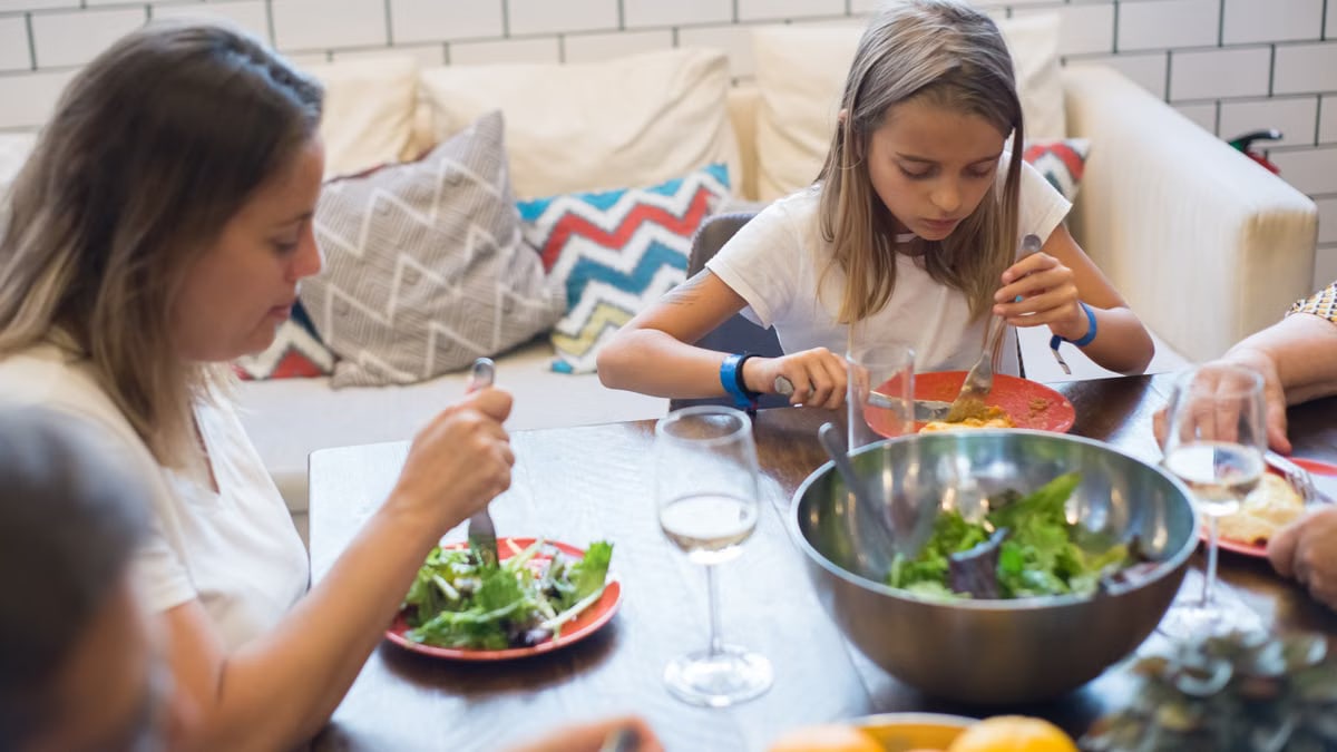 A family enjoying a healthy meal together indoors, emphasizing togetherness and healthy eating.